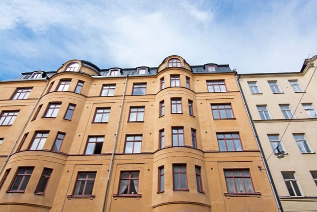 Gult lägenhetshus i sten i Stockholm